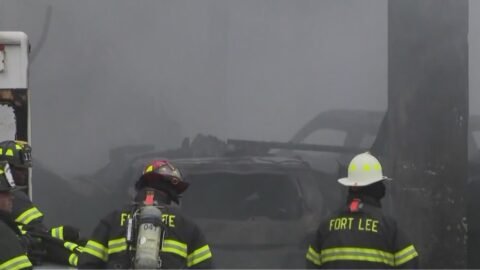 Crews battle three-alarm fire at auto shop